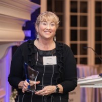 Women holds Kyra Harris Bolden's award